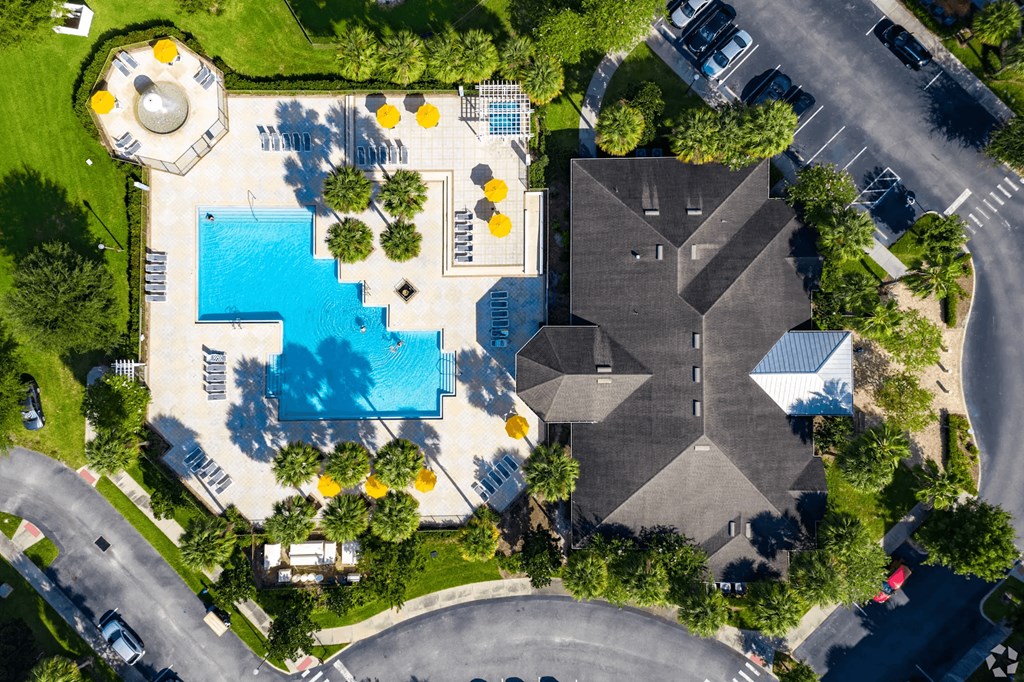 A large building with a pool in front of it.