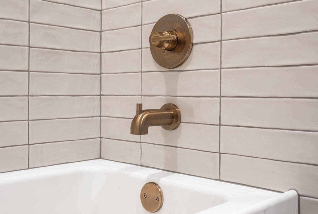 a bathroom with a bath tub and a faucet in it