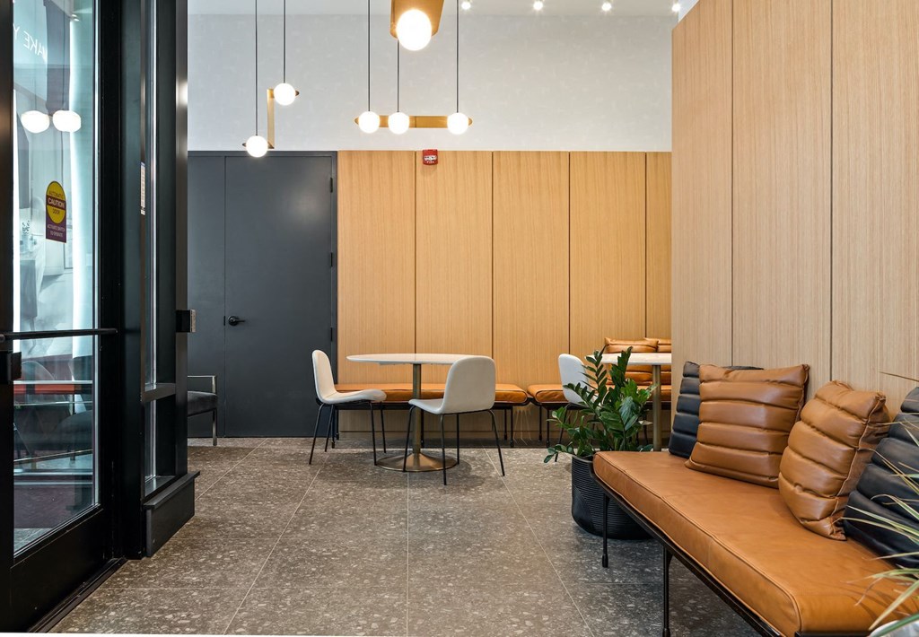 a seating area with a table and chairs in a lobby