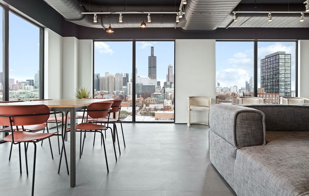 a living room with a table and chairs and a view of the city