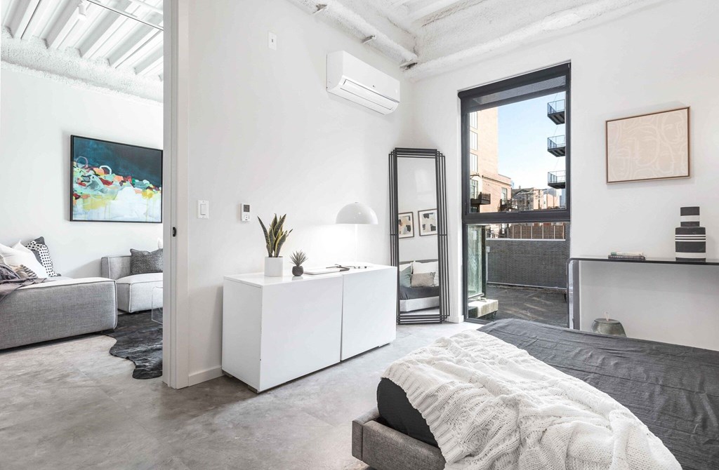 a bedroom with a bed and a white cabinet