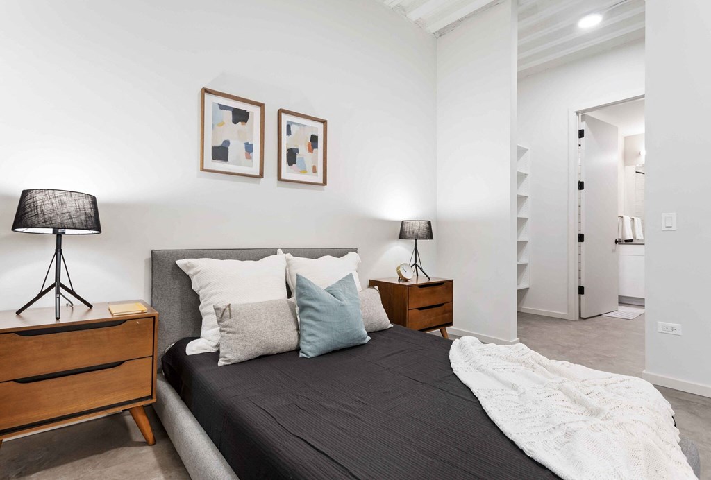 a bedroom with a bed and two night stands