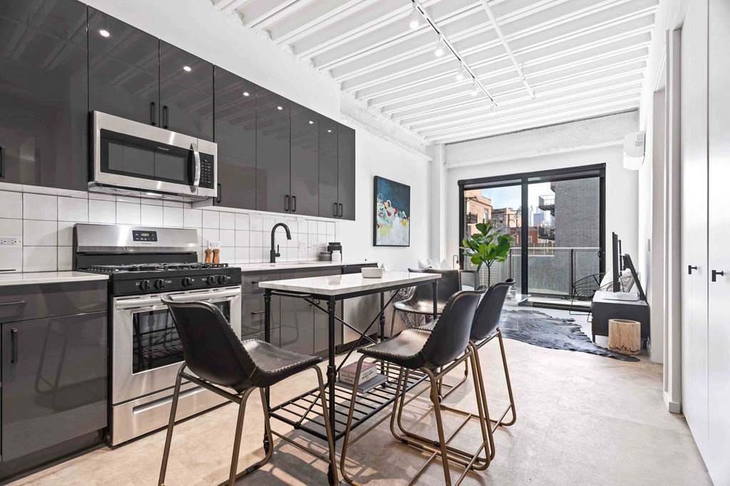 a kitchen with a counter and a table with chairs