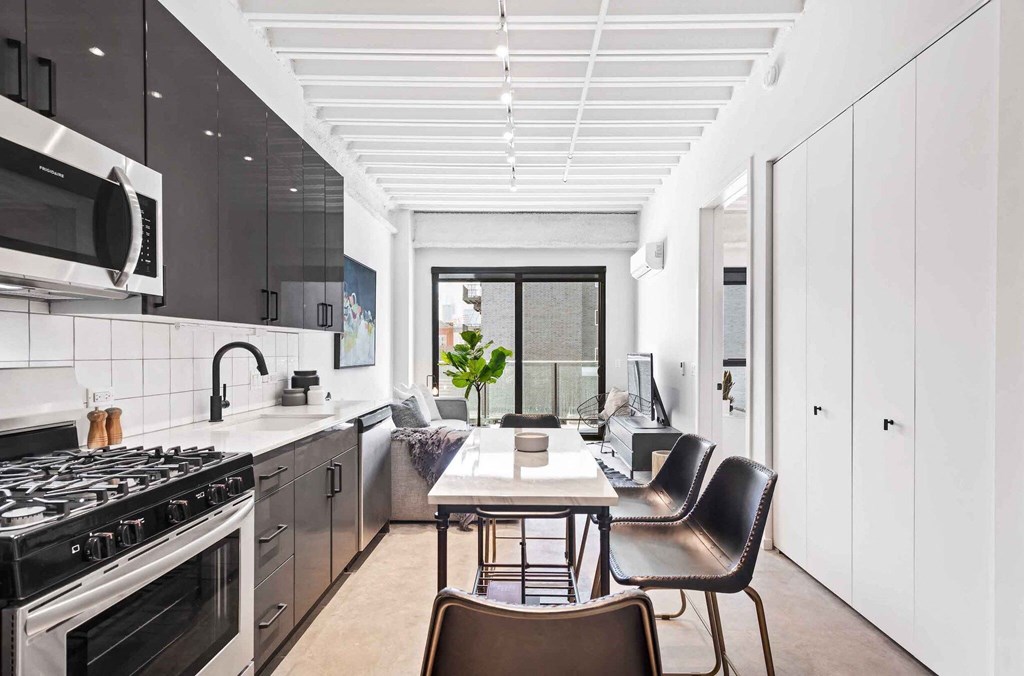 a kitchen and dining room with a table and chairs