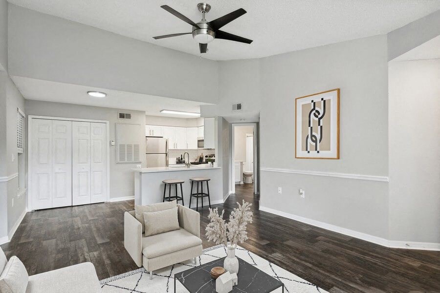 Model living room with view of kitchen