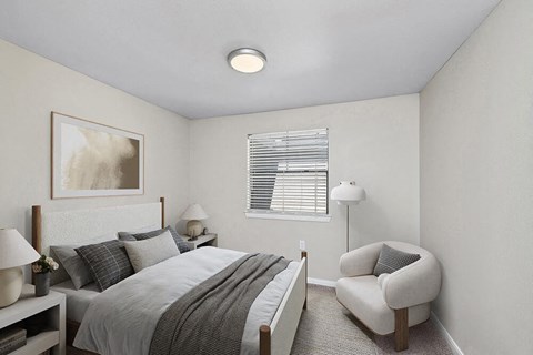 Model Bedroom with Carpet and Window View at Hidden Creek Apartments in Lewisville, TX.