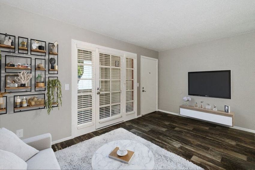 Model living room showcasing wood-style flooring