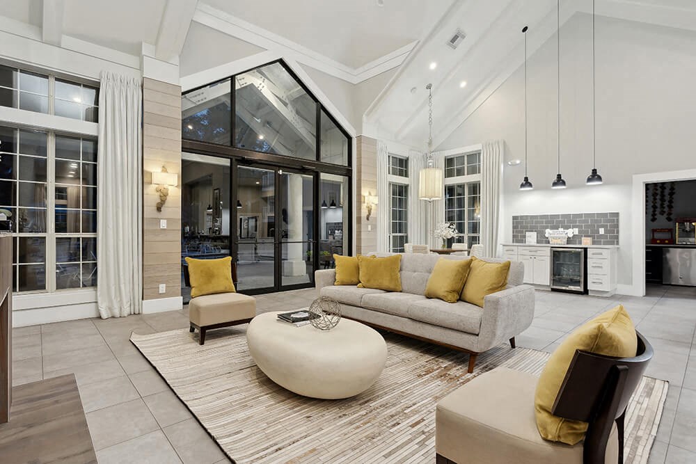 Community Clubhouse with Lounge Furniture and Kitchenette Area at Caribbean Breeze Apartments in Tampa, FL.