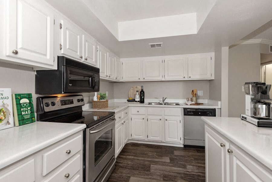 Model apartment kitchen with white cabinets and appliances at Saratoga Ridge, Phoenix, Arizona