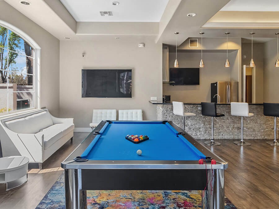 Community Clubhouse with Game Tables & Kitchenette Area at Reserve at Rancho Apartments located in Moreno Valley, CA.