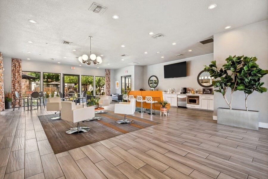 Community Clubhouse with Lounge Furniture and TV at Harmony at Surprise Apartments in Surprise, AZ.