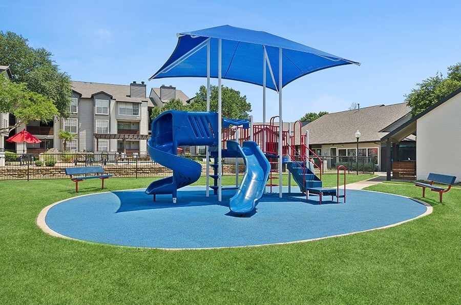 Community Playground with Two Slides at Cobblestone Apartments located in Arlington, TX.