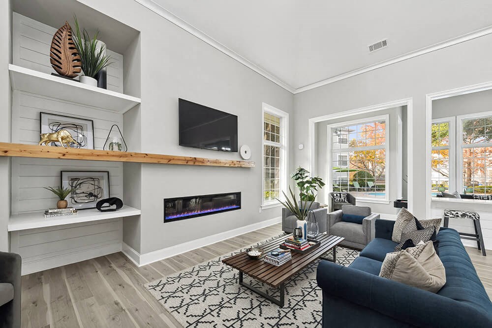 Community Clubhouse with Lounge Furniture and Fireplace at Bridges at Oakbend Apartments in Lewisville, TX.