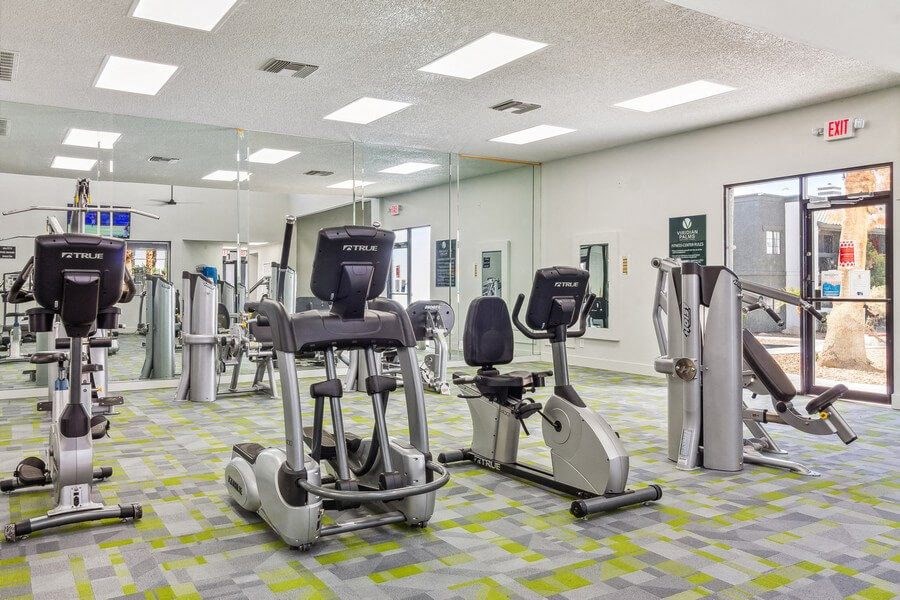 a room filled with lots of different types of exercise equipment