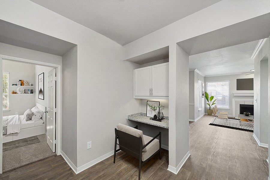 Model Office Area with Wood-Style Flooring and Built in Desk at Chapel Hill Apartments in Lewisville, TX.