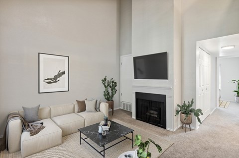 the living room of a home with a couch and a fireplace