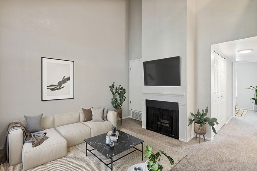 Model Living Room with Carpet and Fireplace at Broadmoor Village Apartments in Salt Lake City, UT.