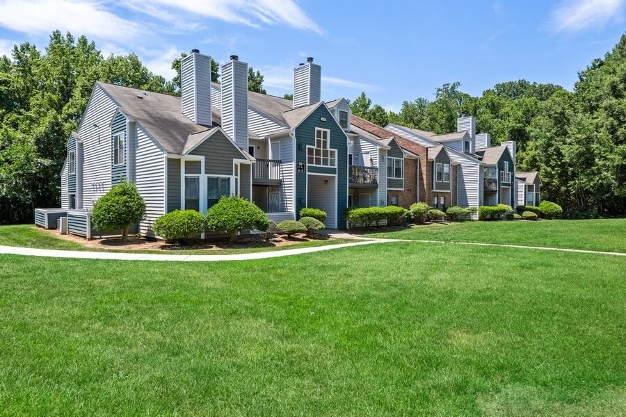 Apartment exterior showcasing well kept landscape