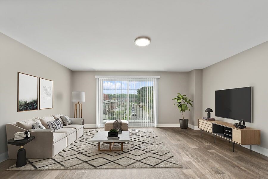 Model Living Room with Wood-Style Flooring and Patio Accessibility at Heights at Marlborough Apartments located in Marlborough, MA.