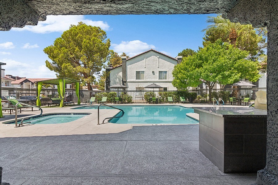 Community Swimming Pool with Pool Furniture at Meadow Ridge Apartments located in Las Vegas, NV.