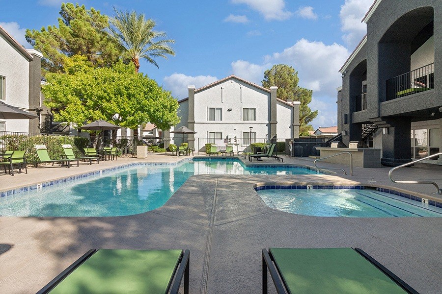 Community Swimming Pool with Pool Furniture at Meadow Ridge Apartments in Las Vegas, NV.