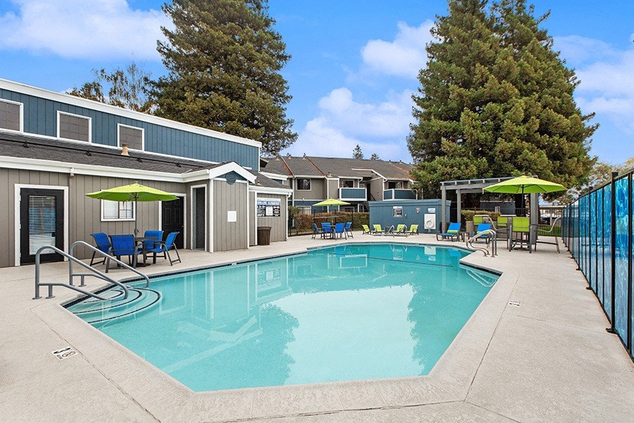 Community Swimming Pool with Pool Furniture at Meritage Apartments in Vallejo, CA.