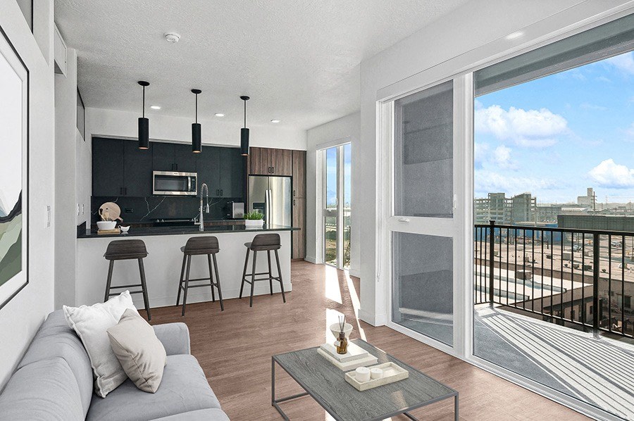Model living room and kitchen at Post House South located in Post District Residences in downtown Salt Lake City, Utah