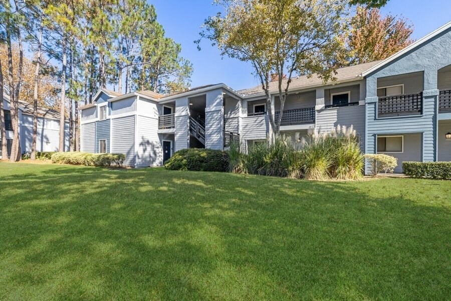 Apartment exterior showcasing landscaping and patios