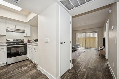 A kitchen with white cabinets and a stainless steel oven.