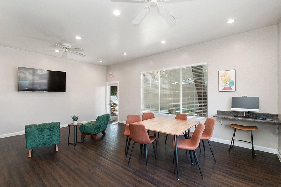 Community Clubhouse with Lounge Furniture & Work Stations at Indigo Park Apartments located in Albuquerque, NM.