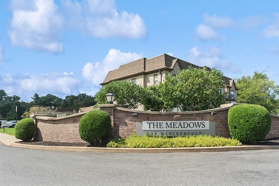 Monument Sign and Front Entrance at Meadows at Marlborough Apartments in Boston, MA.