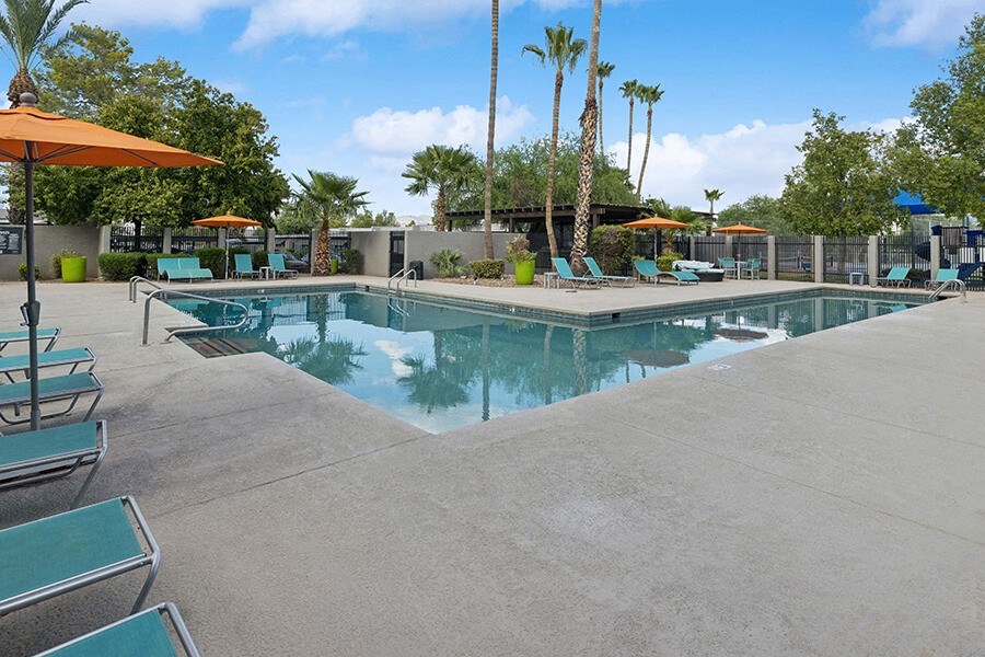 Community Swimming Pool with Pool Furniture at Lakeside Casitas Apartments located in Tucson, AZ.