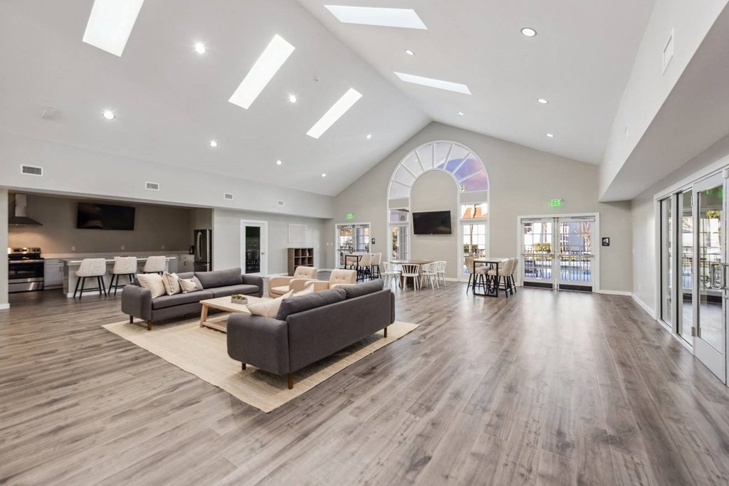 a large living room with couches and chairs and a large glass door