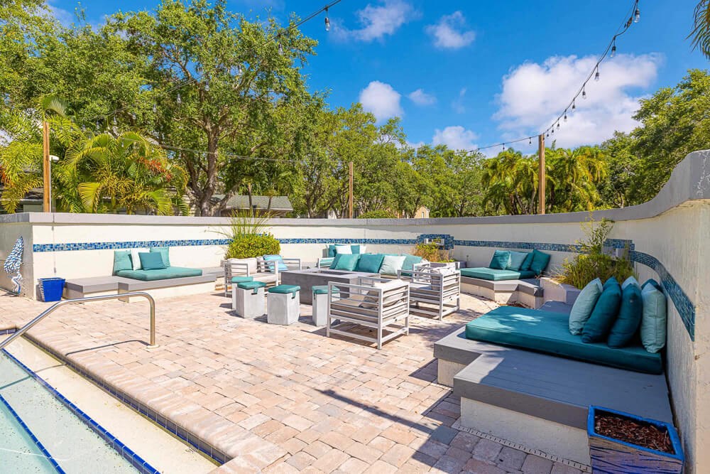 Firepit lounge near pool at Huntington Place Apartments in Sarasota, Florida