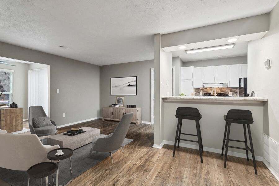 a living room with a bar and a kitchen