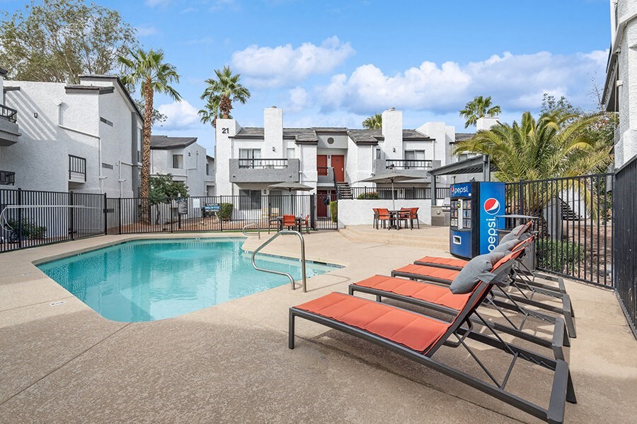 Community Swimming Pool with Pool Furniture at Crystal Creek Apartments in Phoenix, AZ.