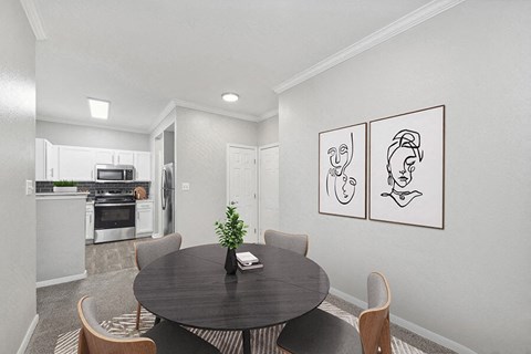 Model Dining Room with Carpet and View of Kitchen Area at Hidden Creek Apartments located in Lewisville, TX.