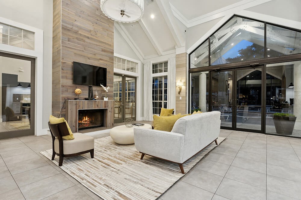 Community Clubhouse with Lounge Furniture and Fireplace at Caribbean Breeze Apartments in Tampa, FL.