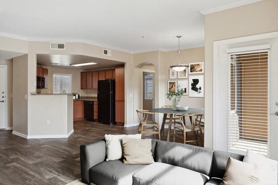 Model living room with view of kitchen at Reserve at Rancho Apartments