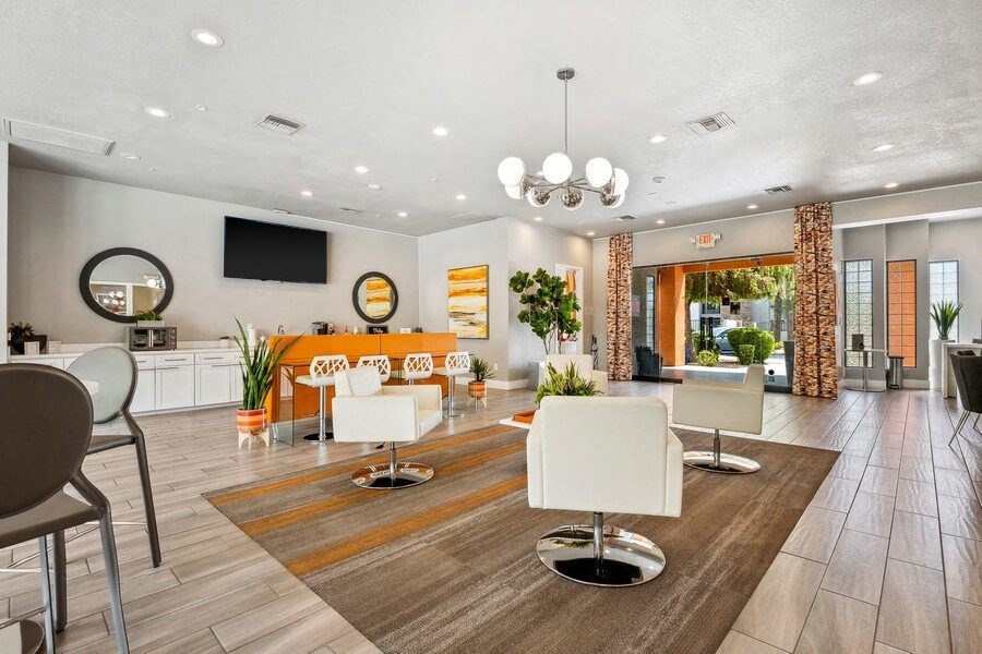 Community Clubhouse with Lounge Furniture and TV at Harmony at Surprise Apartments in Surprise, AZ.