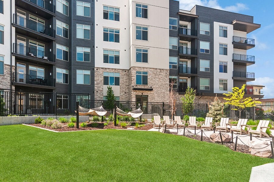 Outdoor Picnic Area with Lounge Furniture and View of Swimming Pool at Seven Skies Apartments located in Sandy, UT.