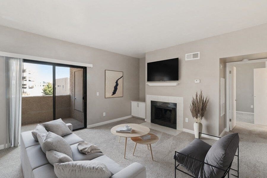 Model living room with fireplace and private patio