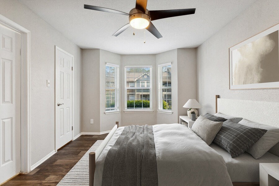 a bedroom with a large bed and a ceiling fan