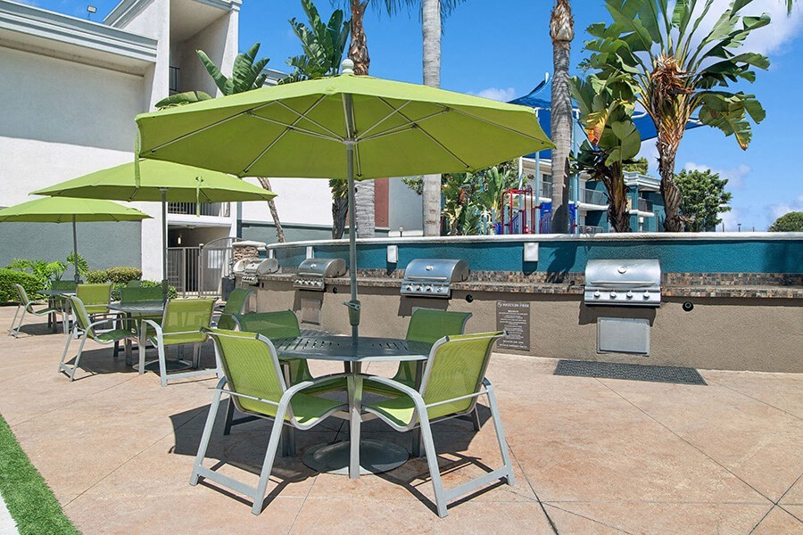 Outdoor BBQ Area with Lounge Furniture at Madison Park Apartments located in Anaheim, CA.