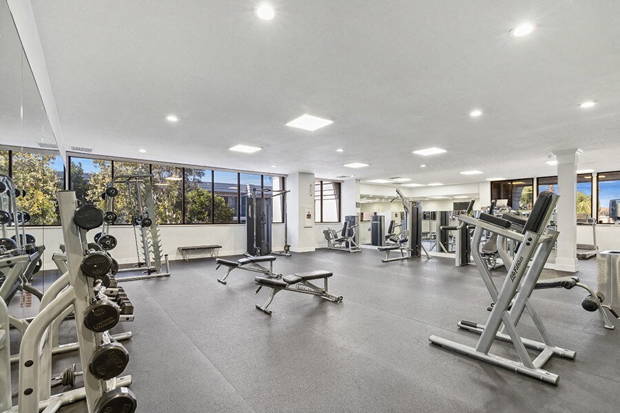Community Fitness Center with Equipment at Madison Park Apartments located in Anaheim, CA.