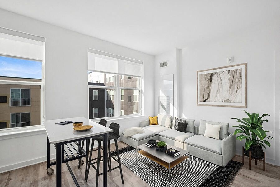 Model Living Room with Wood-Style Flooring and Window View at Stella Apartments located in New Carrollton, MD.