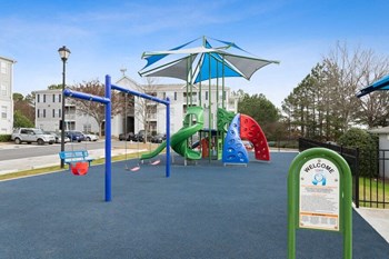 Community playground with soft play top at Retreat at Stonecrest Apartments - Photo Gallery 19