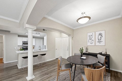 a dining room and kitchen with a table and chairs