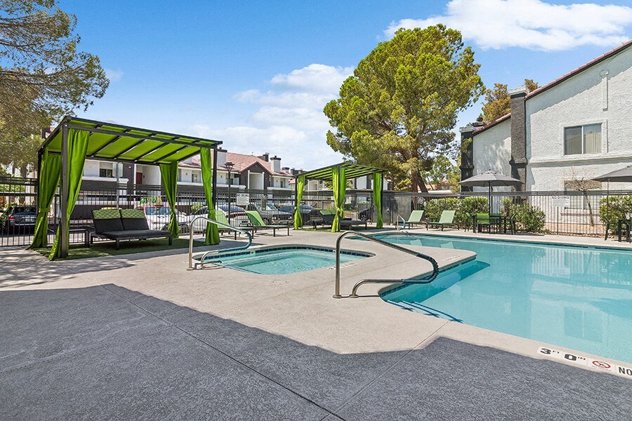 Community Swimming Pool with Pool Furniture at Meadow Ridge Apartments located in Las Vegas, NV.