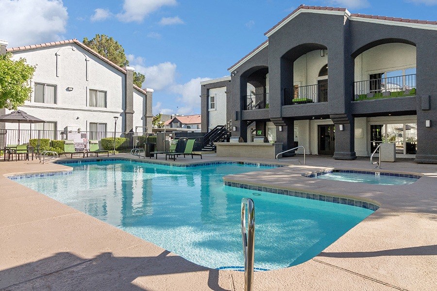 Community Swimming Pool with Pool Furniture at Meadow Ridge Apartments in Las Vegas, NV.